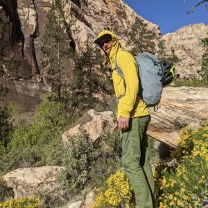 Man surrounded by greenery and flowers 