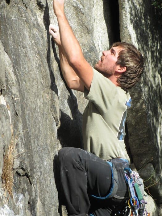 Person climbing a mountain face 