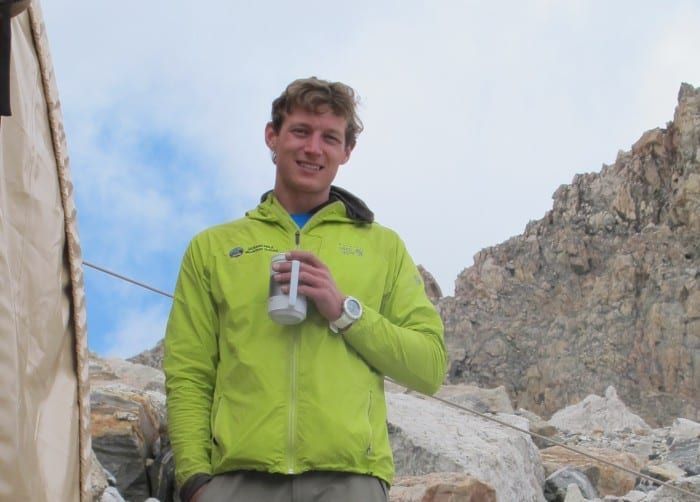 Person enjoying drink in the mountains 