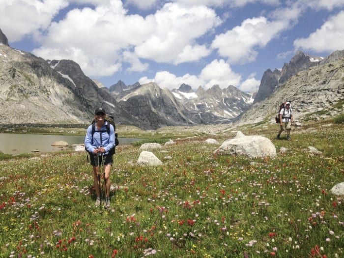 Hikers in field of flowers 