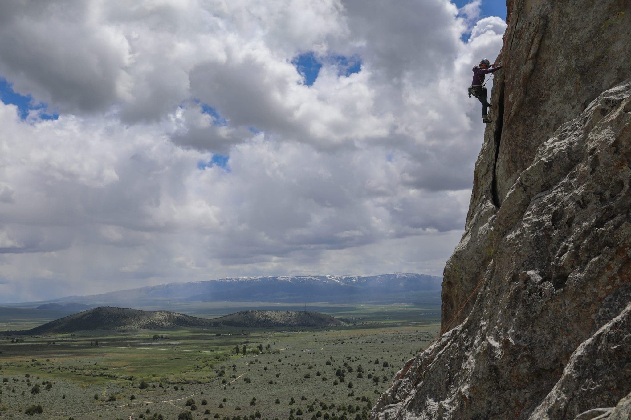Person climbing on side of mountain