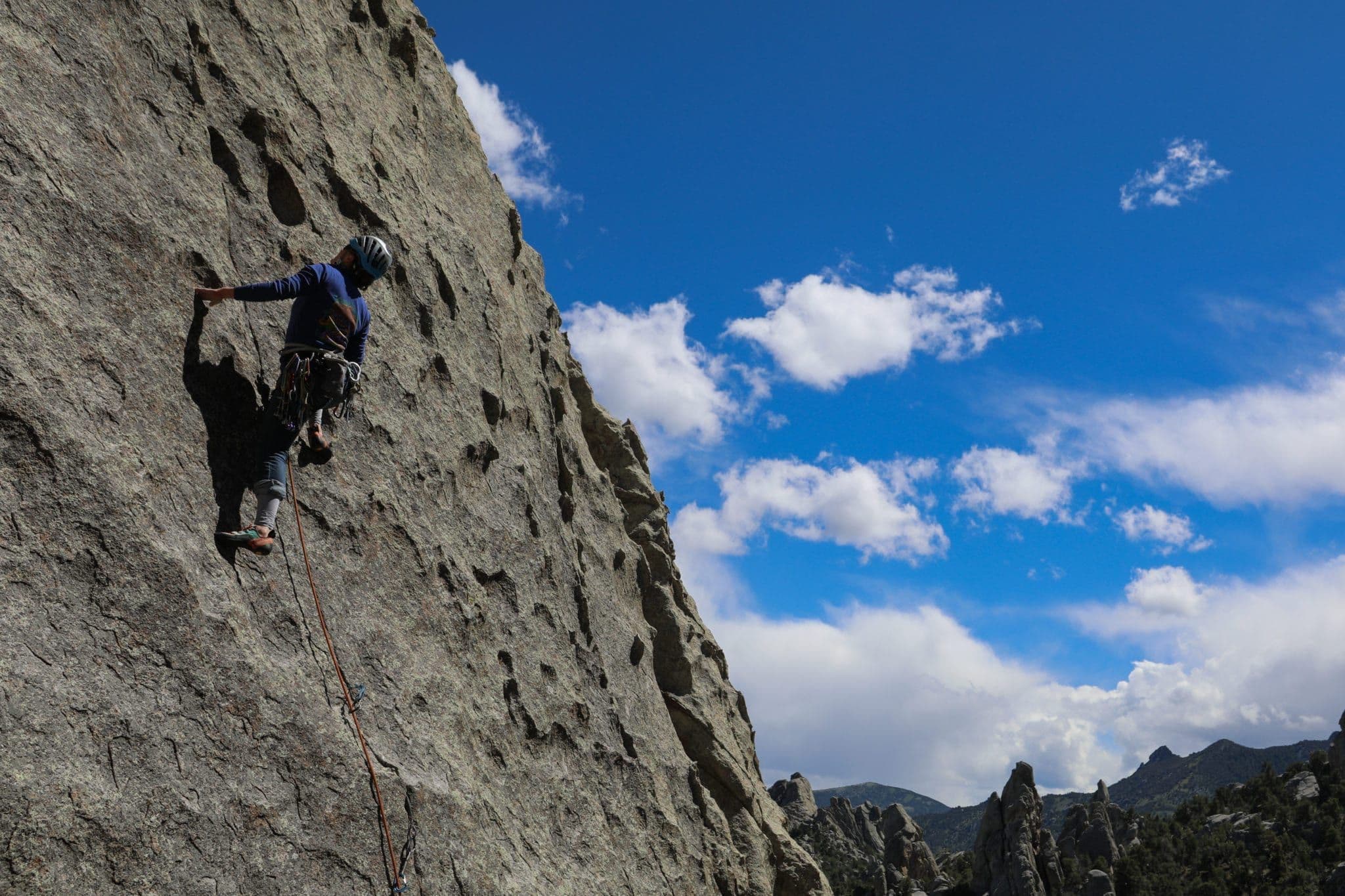 Climber scaling side of a mountain 
