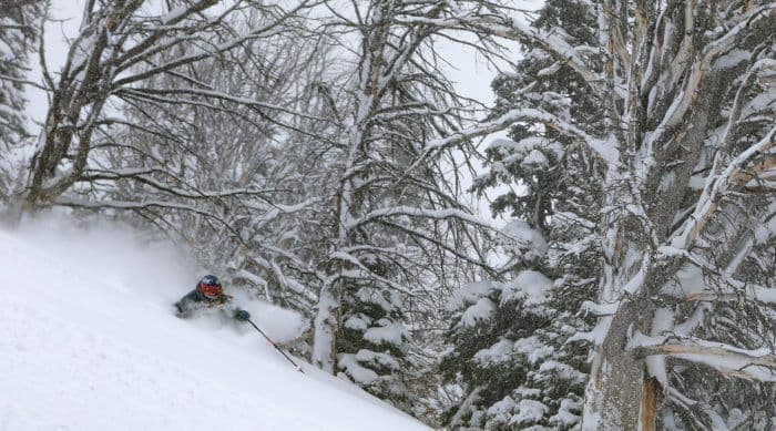 Skier going down deep powder 