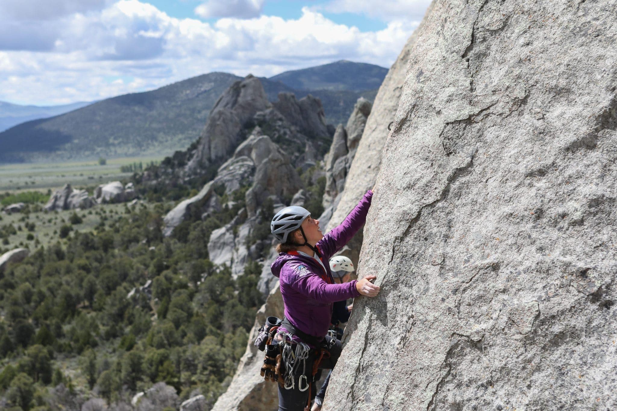 Woman rock climbing on mountain side 