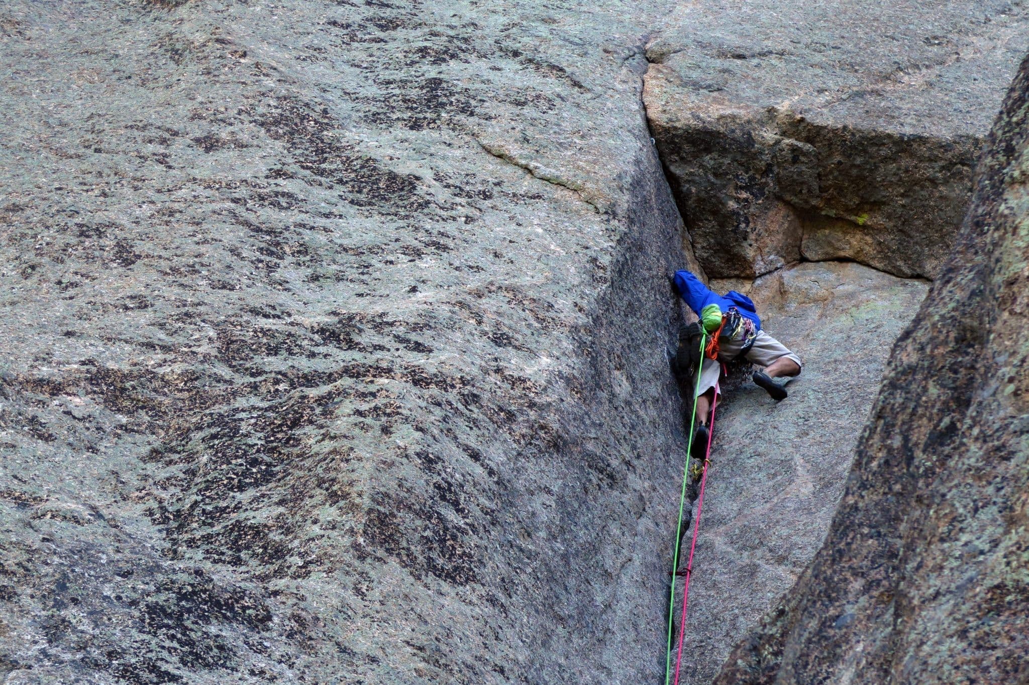 Person carefully rock climbing 