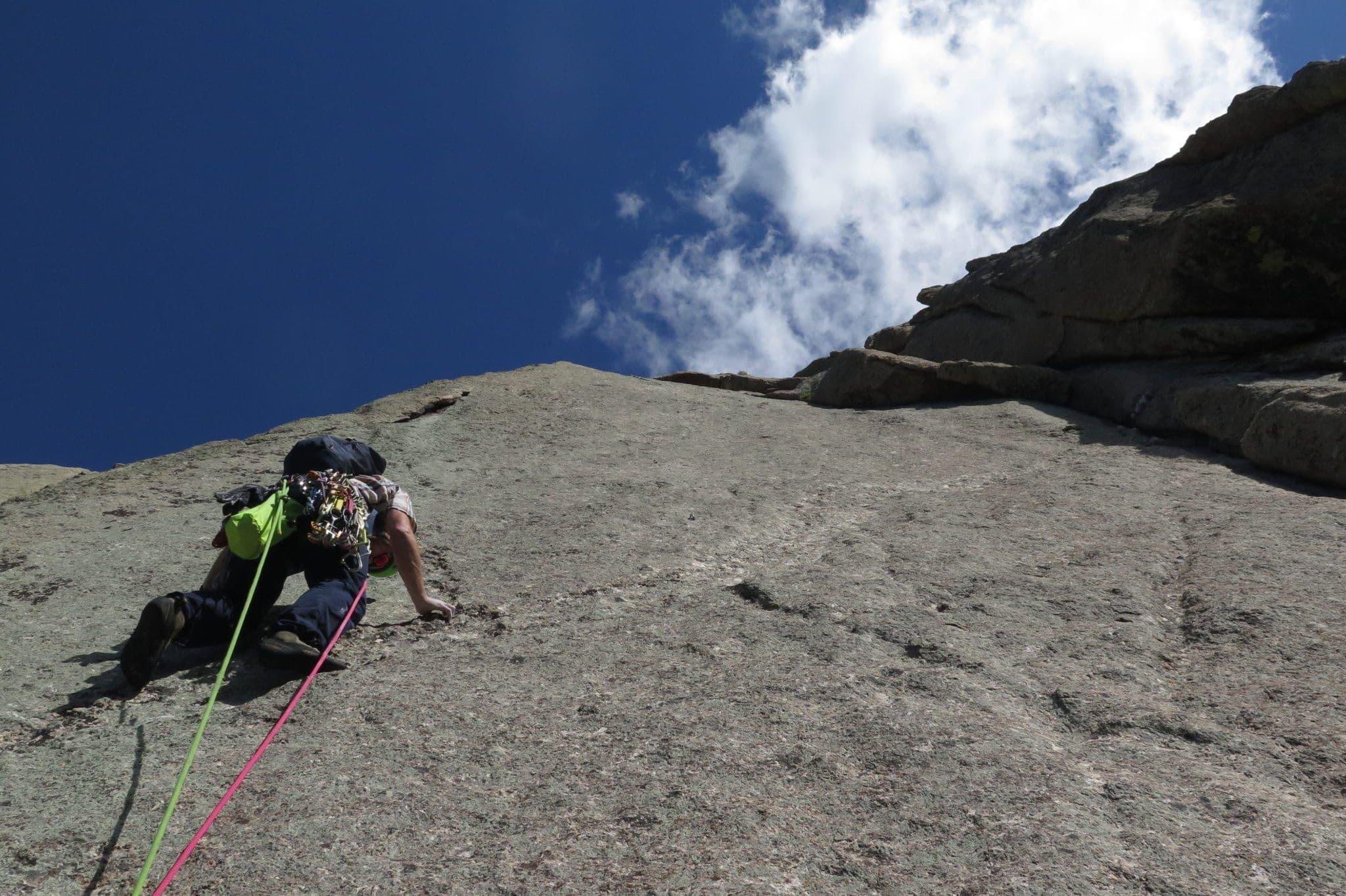 Climber scaling steep mountainside 