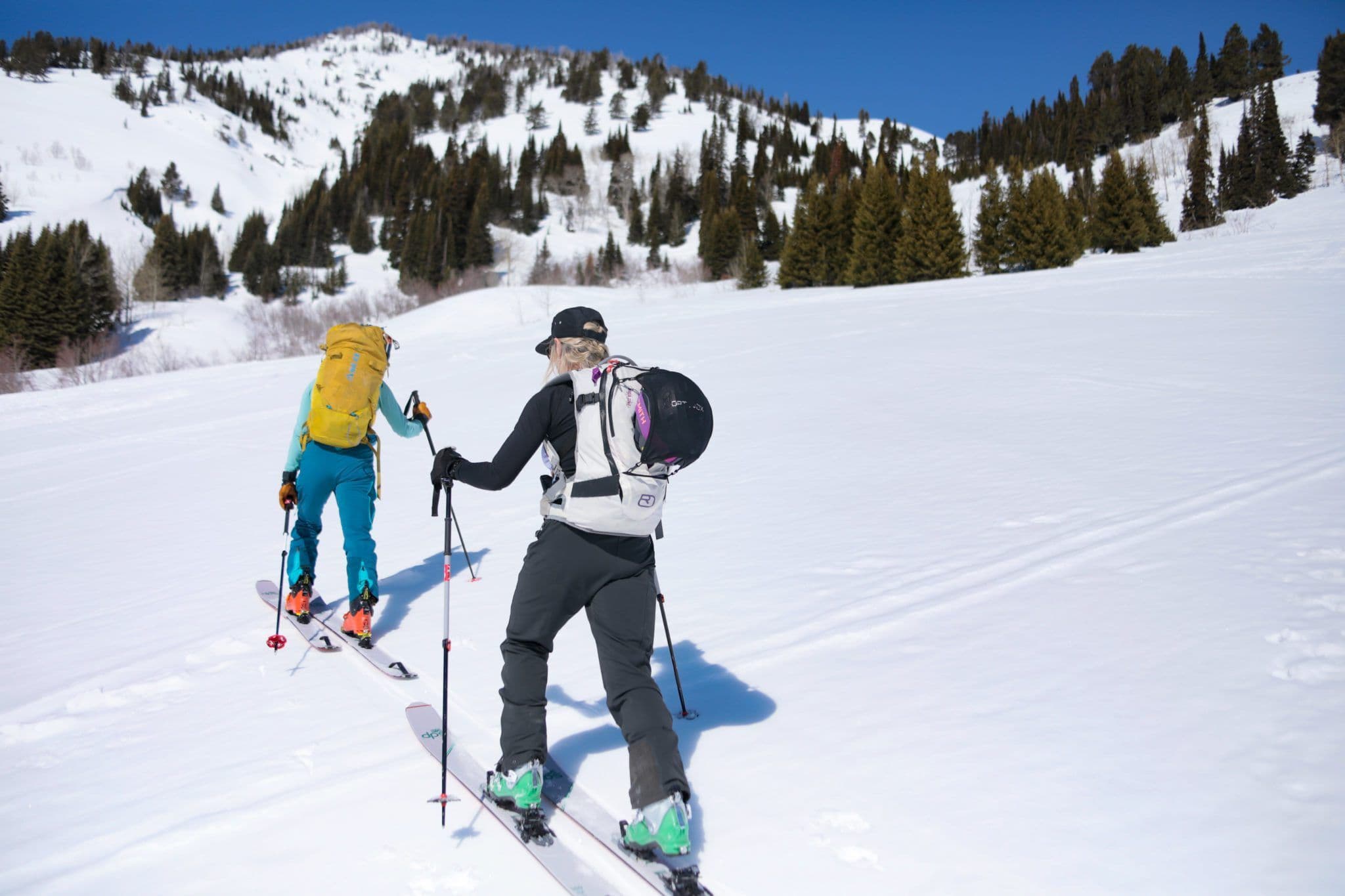Pair of skiers climbing a mountain in Grand Teton national park