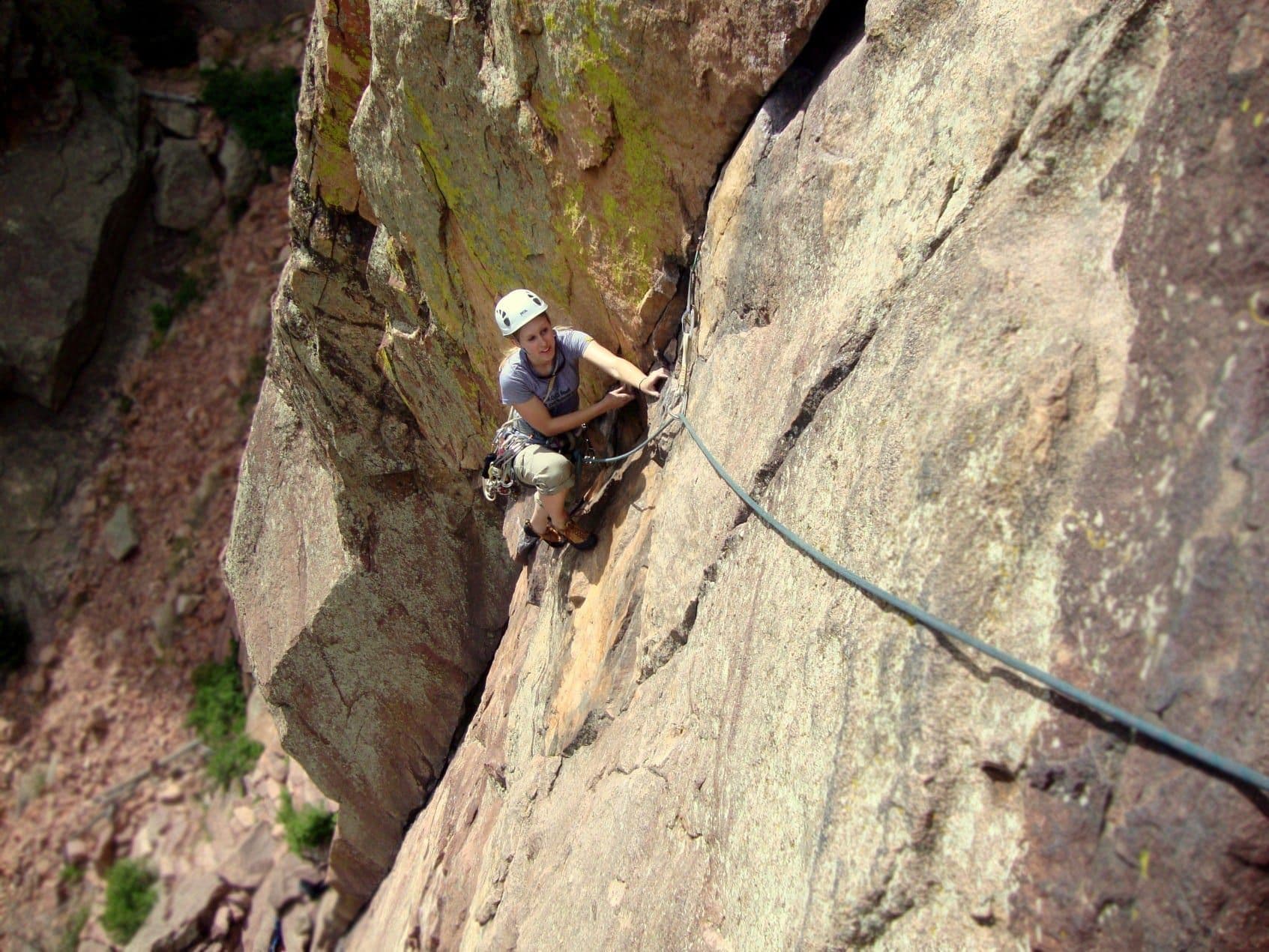 Woman climbing steep terrain in Rocky Mountain national park 