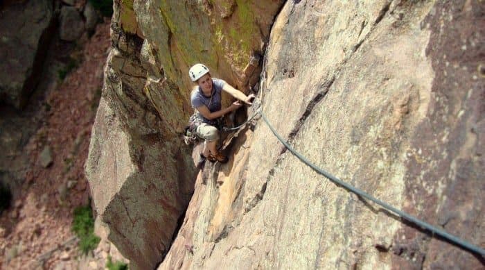 Person climbing steep rocky terrain 