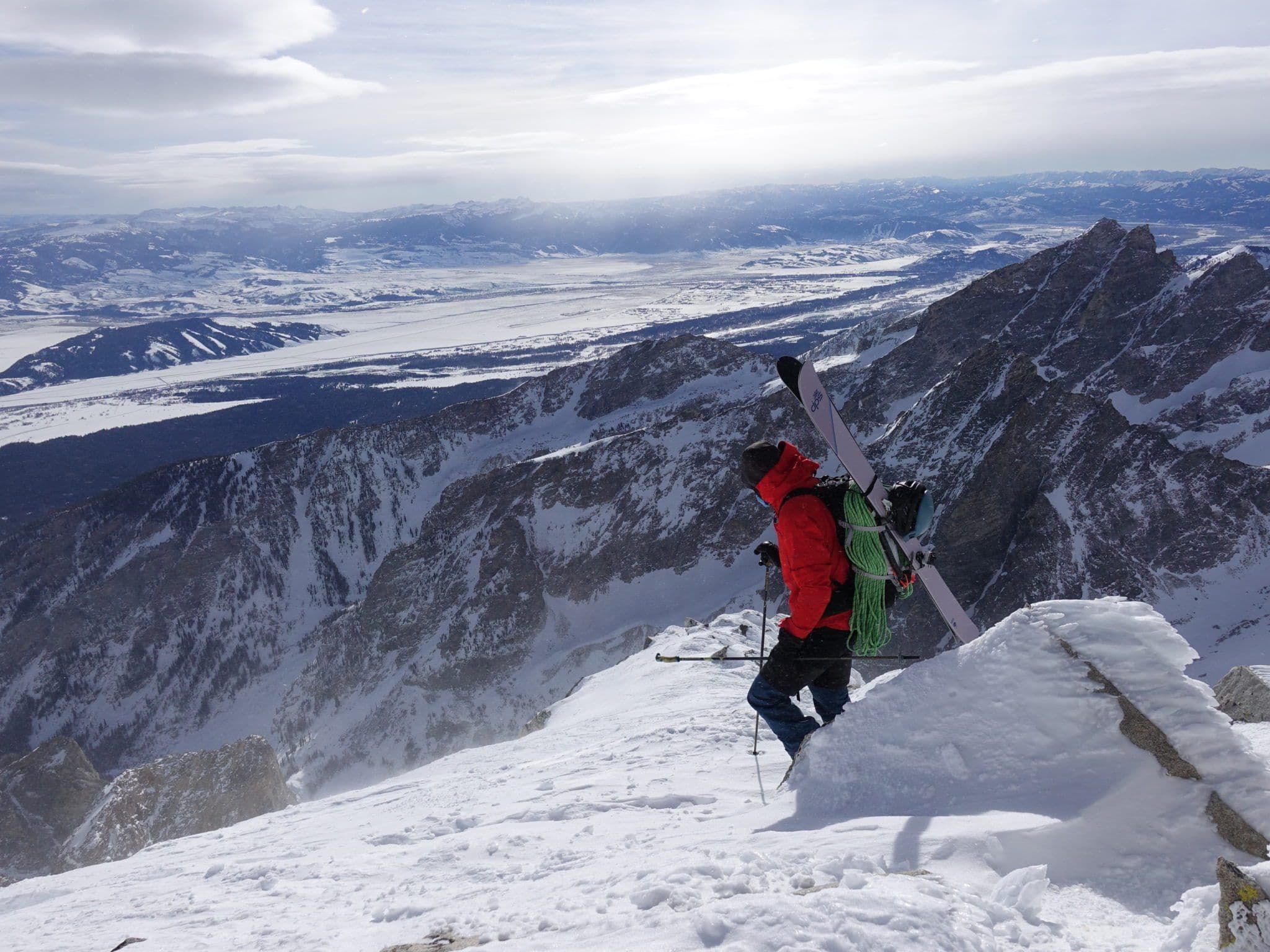 Skier climbing to top of mountain 