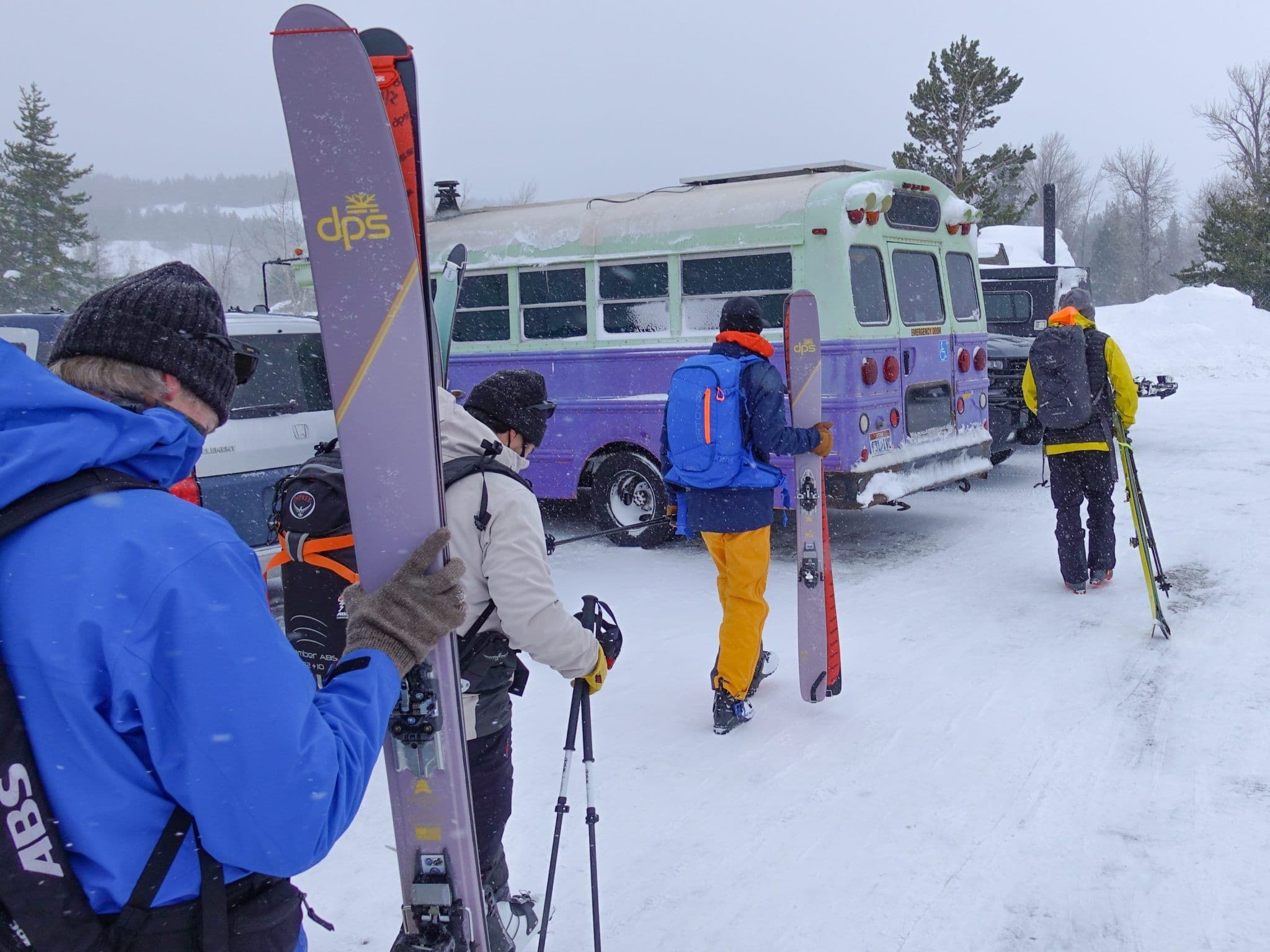 Team walking towards bus with skis