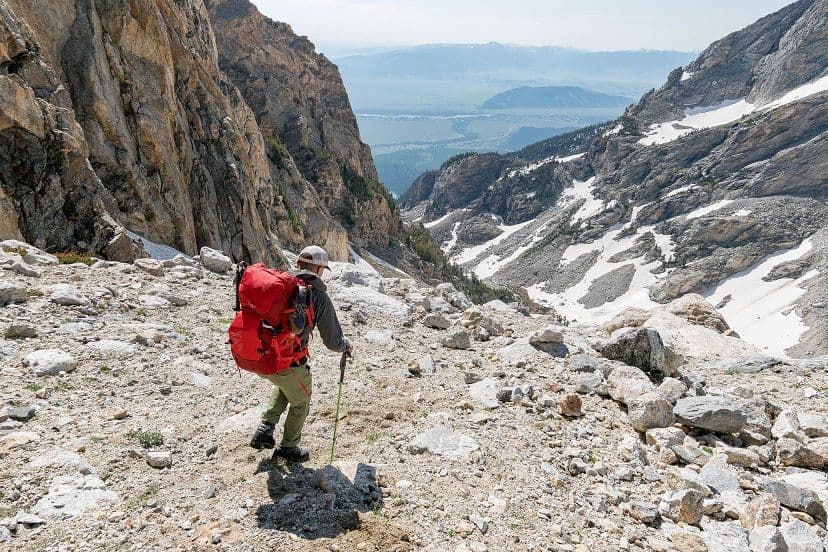Hiker going down rocky terrain 