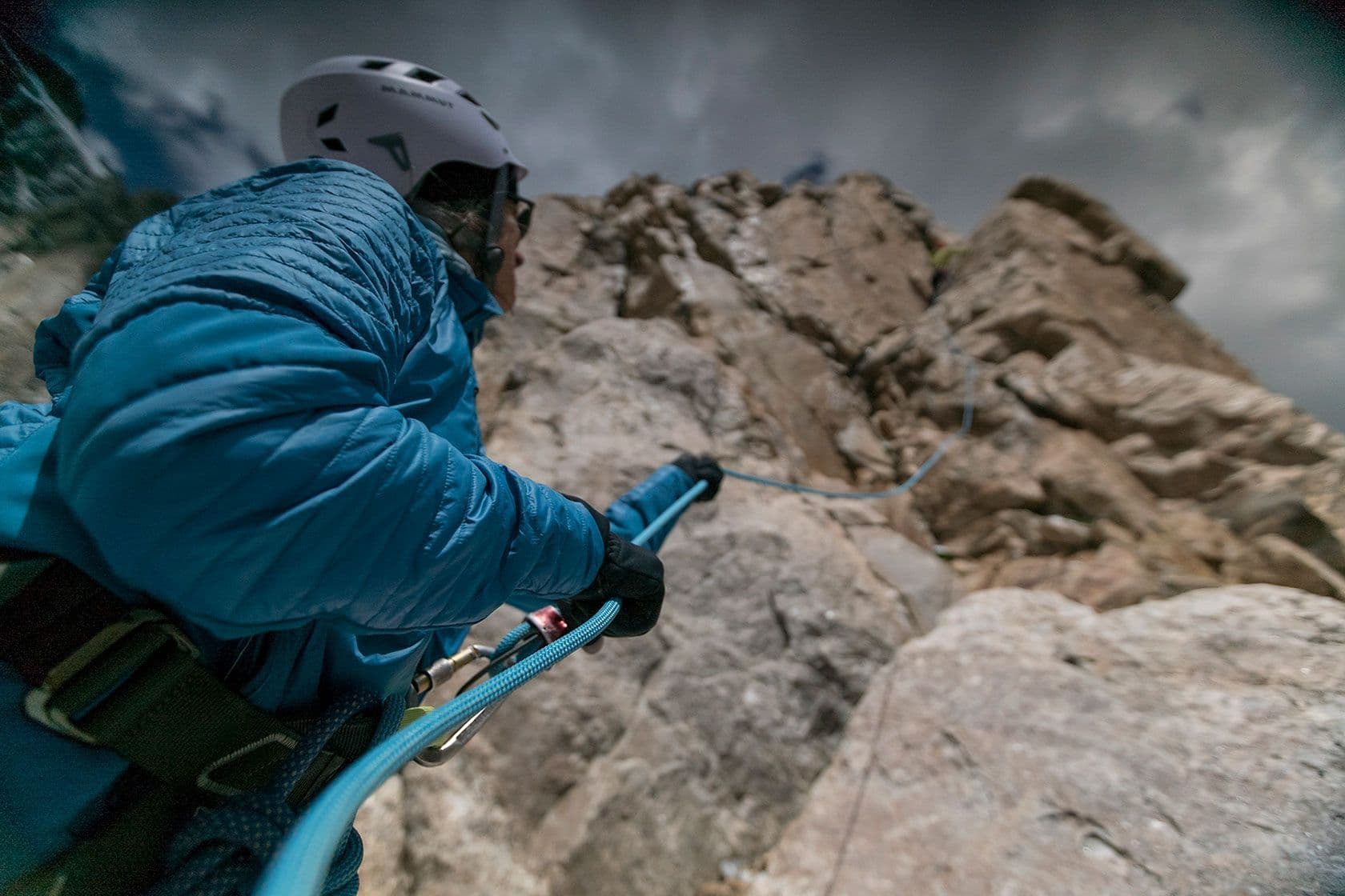 Person assisting in rock climb in Grand Teton