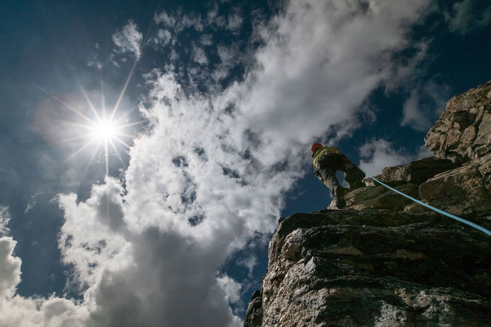 Person rock climbing in grand Teton national park 