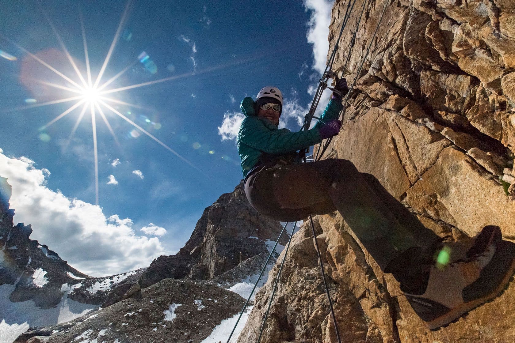 Person climbing side of summit in Grand Teton