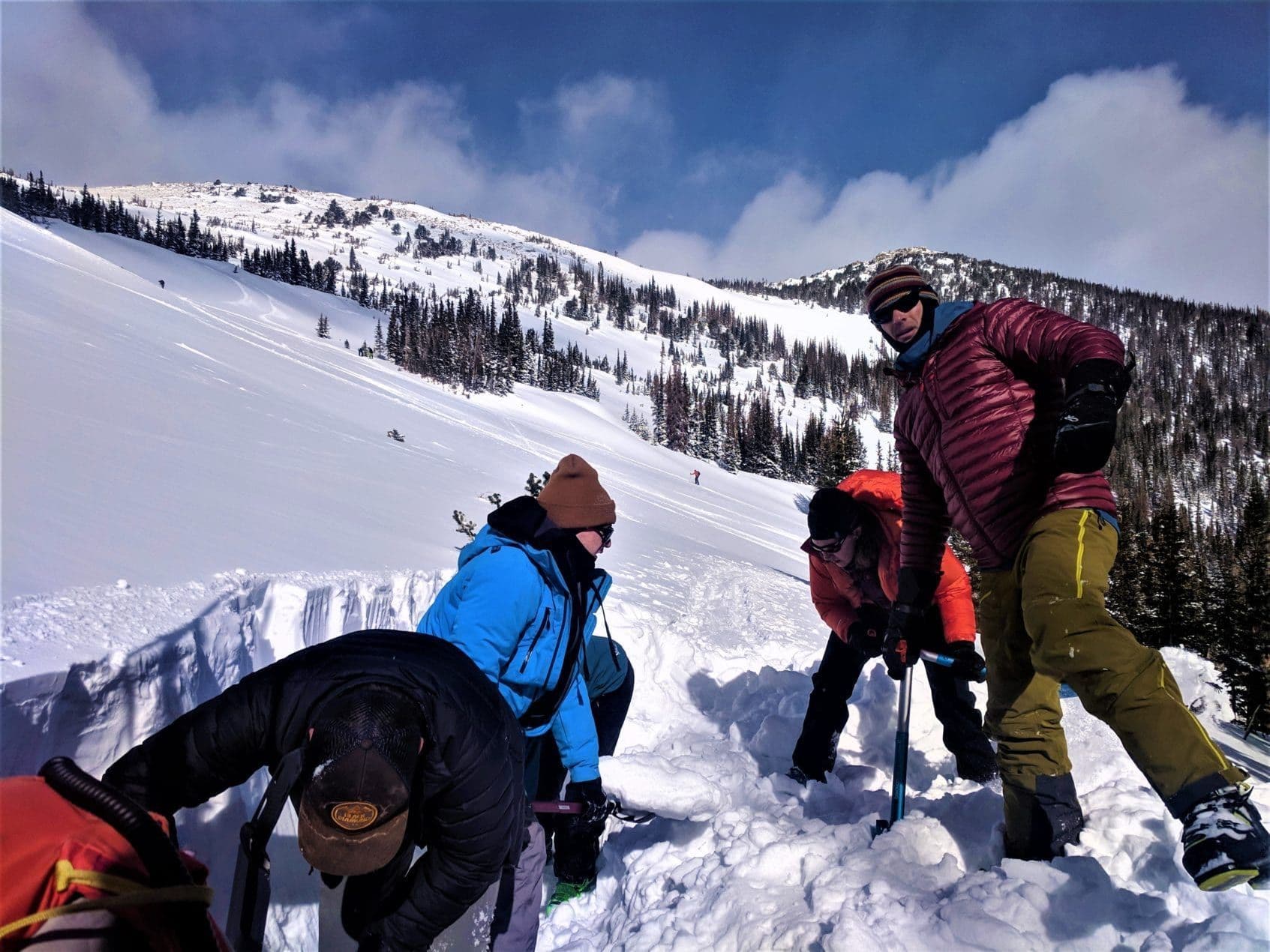 Group shoveling snow in avalanche course 