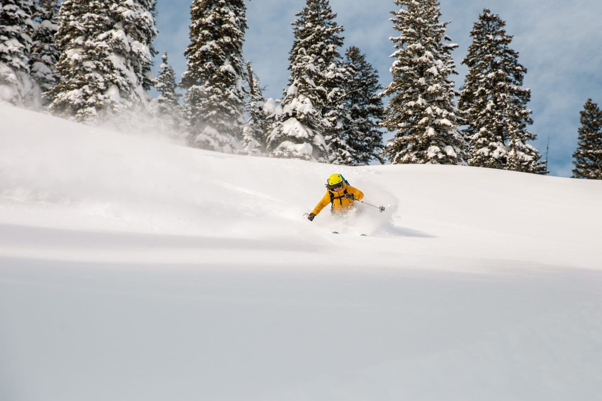 Person backcountry skiing in deep powder