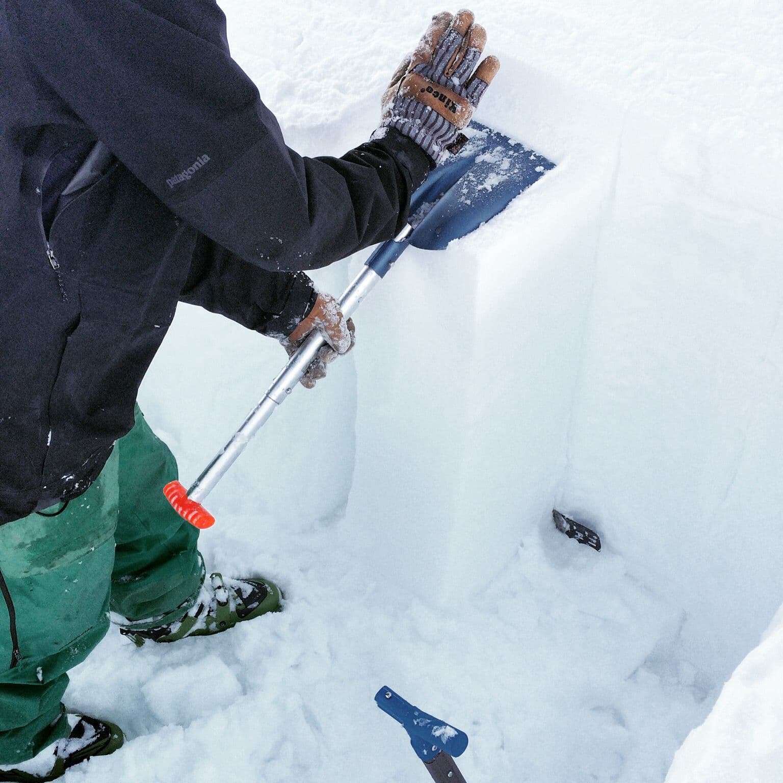 Person packing down snow