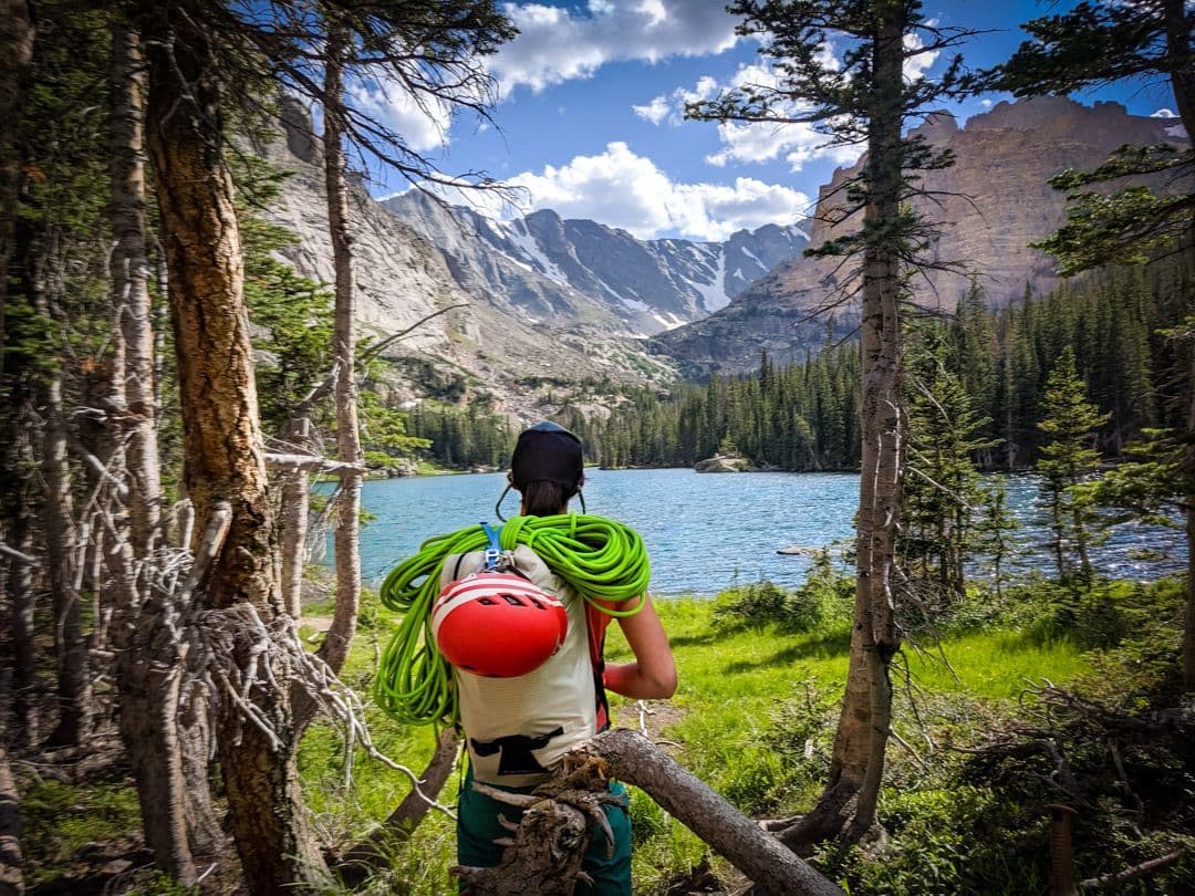 Climber enjoying the view of a lake a mountains 