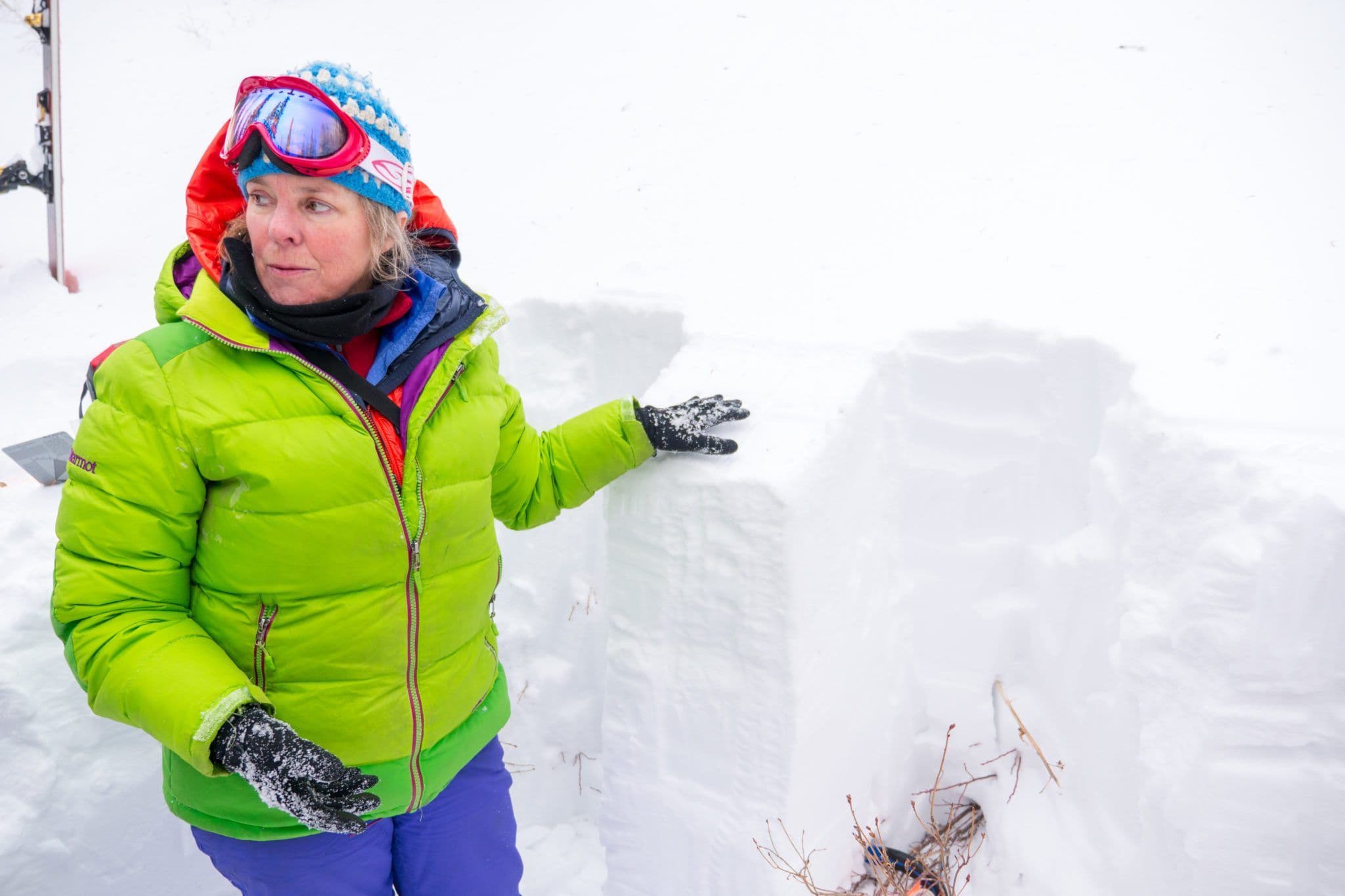 Woman demonstrating depth of snow in avalanche course 