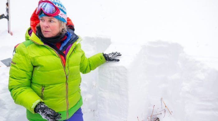 Women showing the depth of the snow