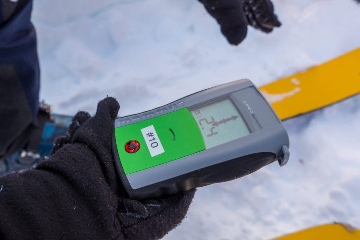 A person holding a avalanche transceiver
