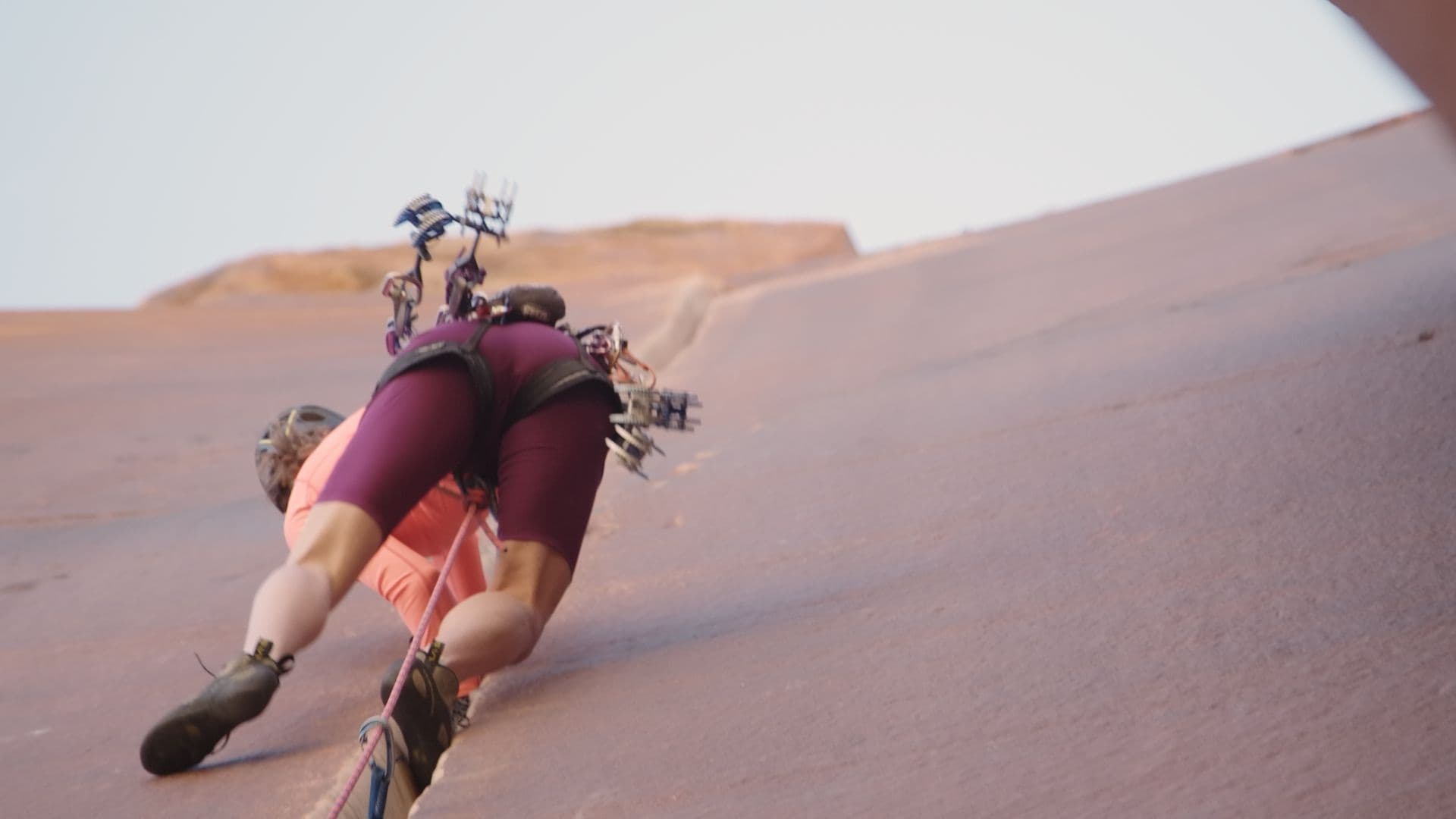 Woman climbing a steep canyon side 