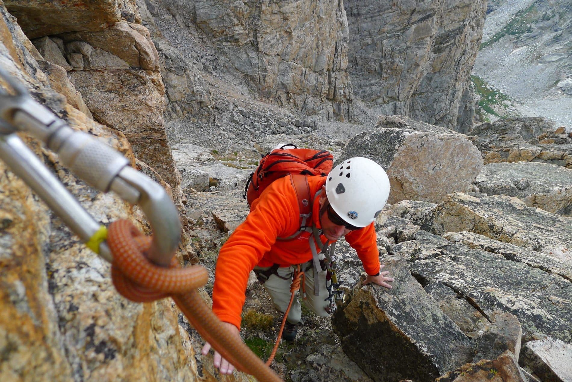 Climber maneuvering rocky terrain in Grand Teton national park 