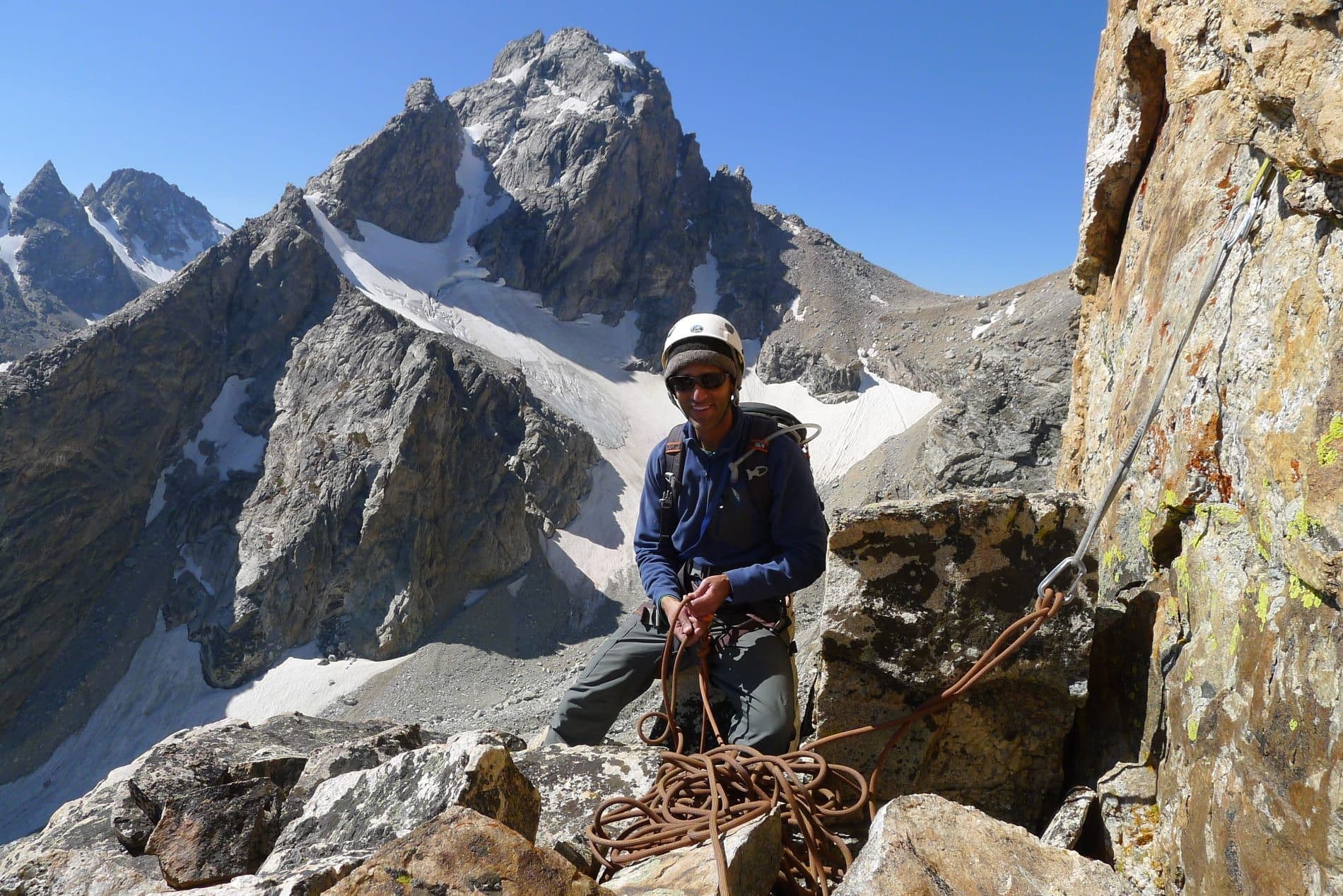 Man on cliffside of Grand Teton national park 