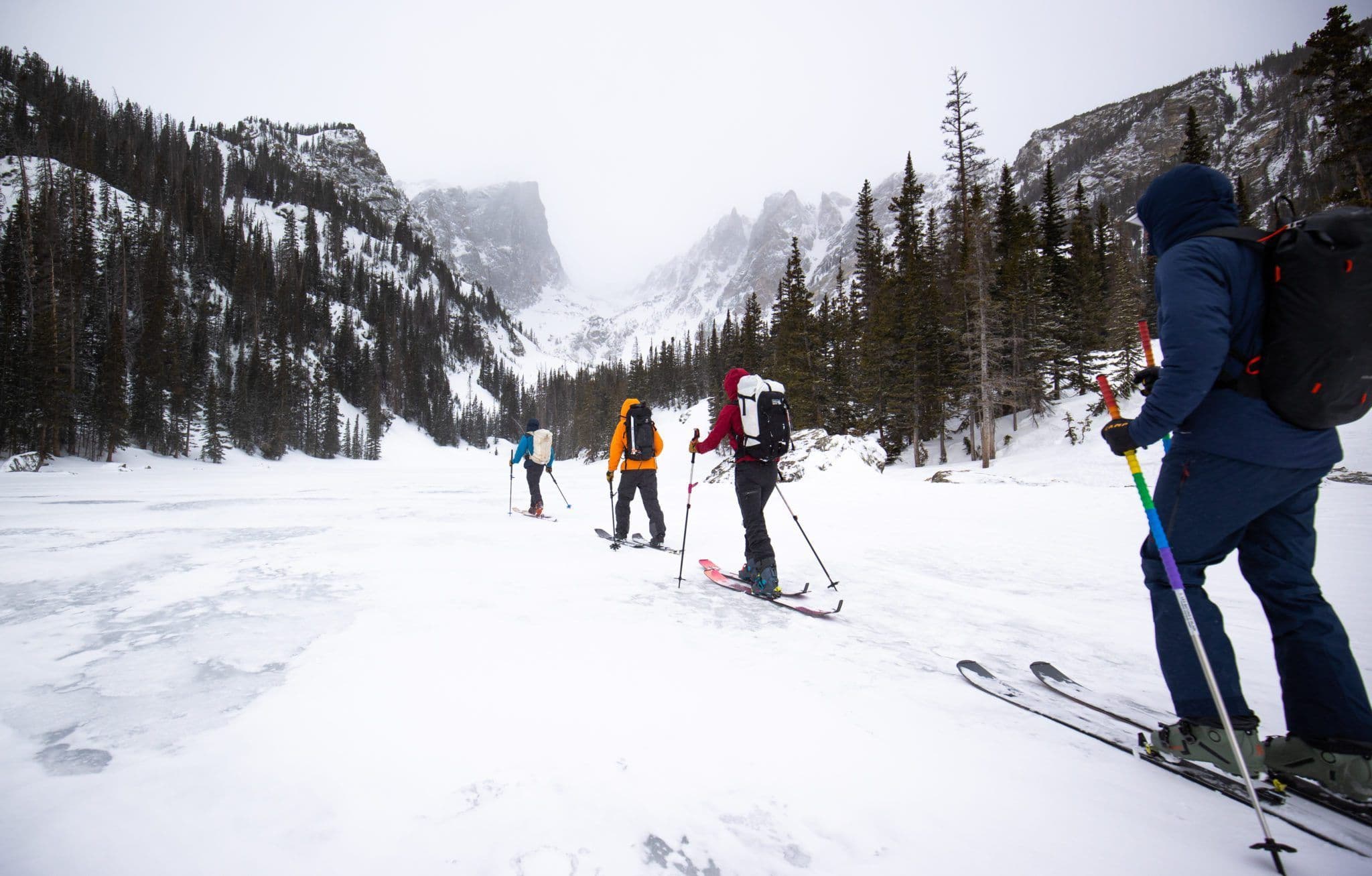 Backcountry skiers hiking to top of mountain 