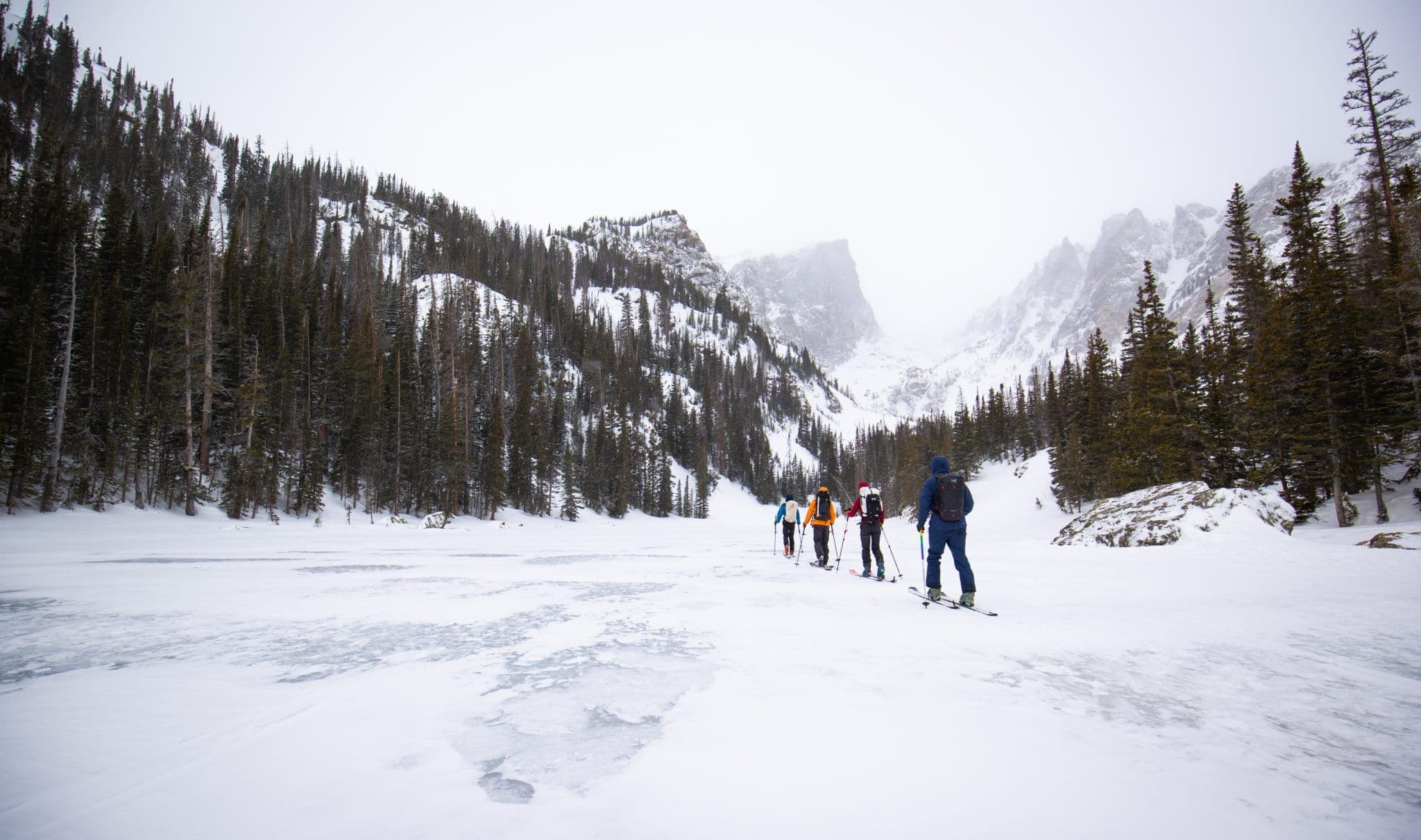 Backcountry skiers climbing snowy terrain 