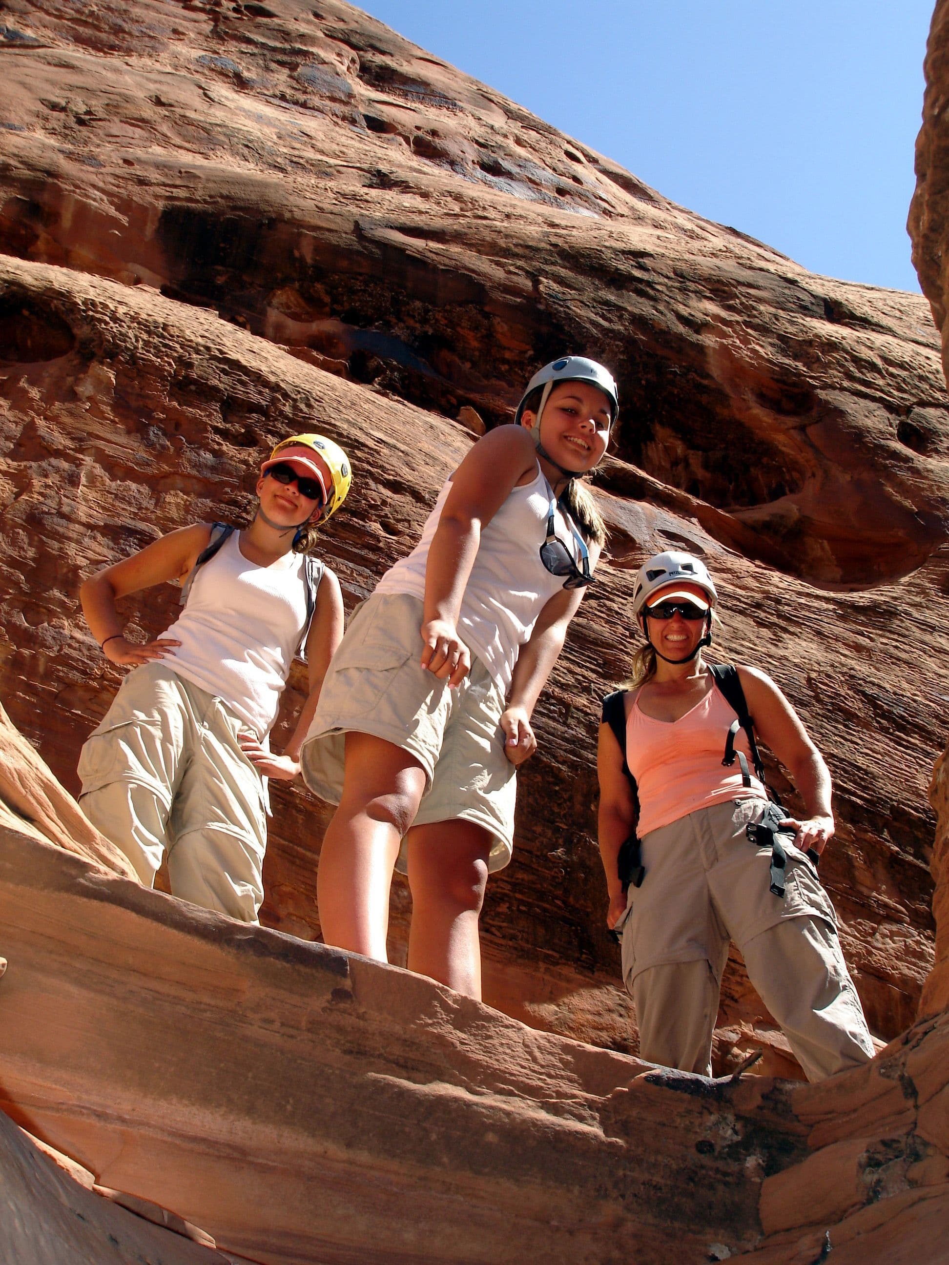Three people hiking in a canyon 