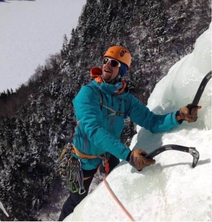 Person climbing using ice picks 