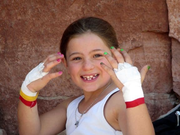 Child showing her hiking gear 