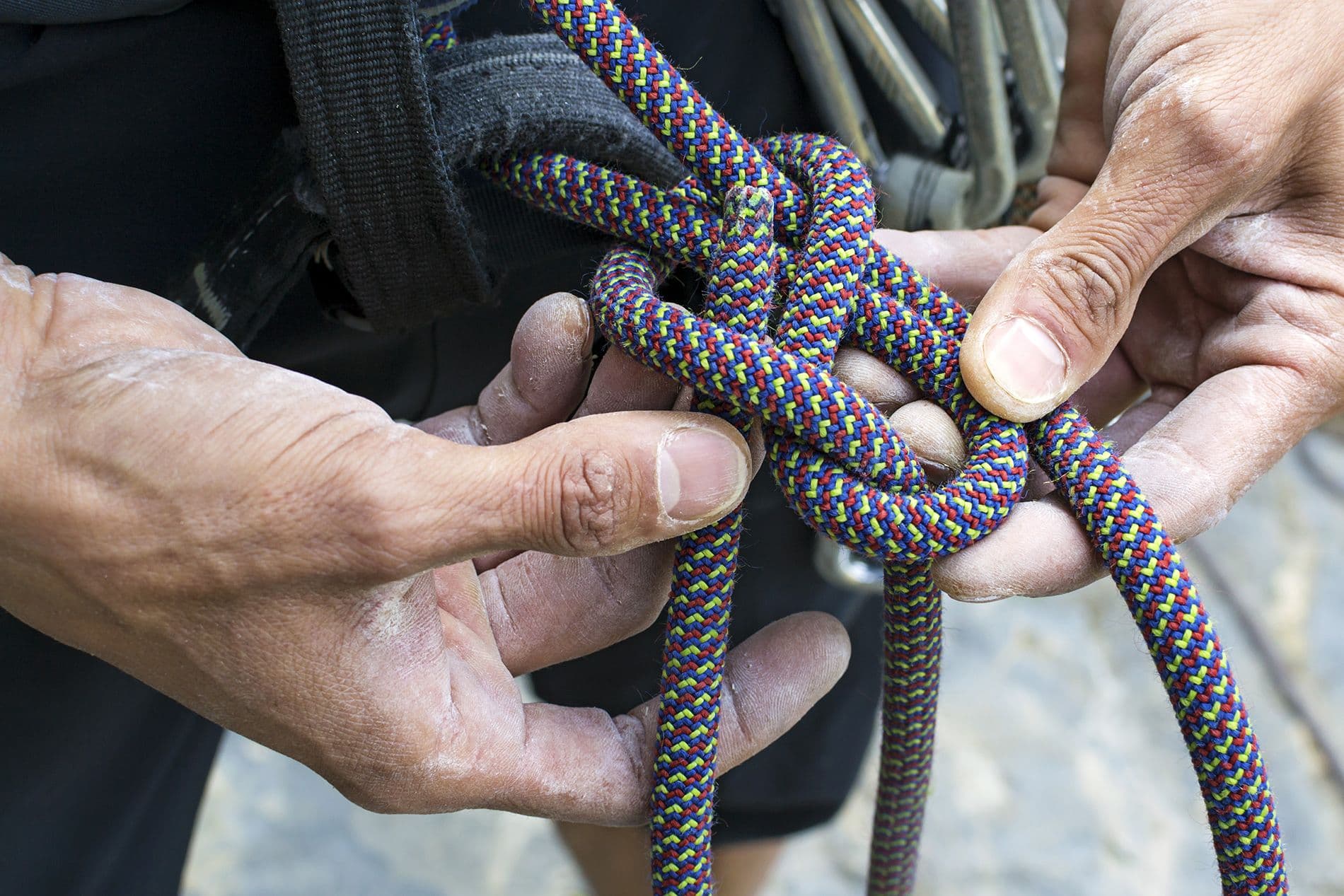 Rock climber tying a figure 8 knot