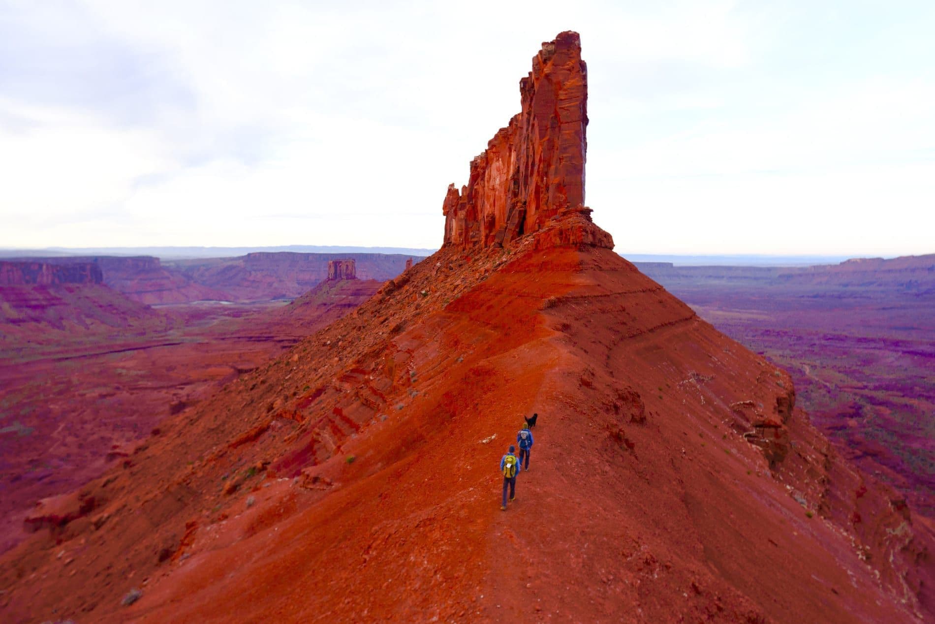 People hiking to the top of peaks in Moab 