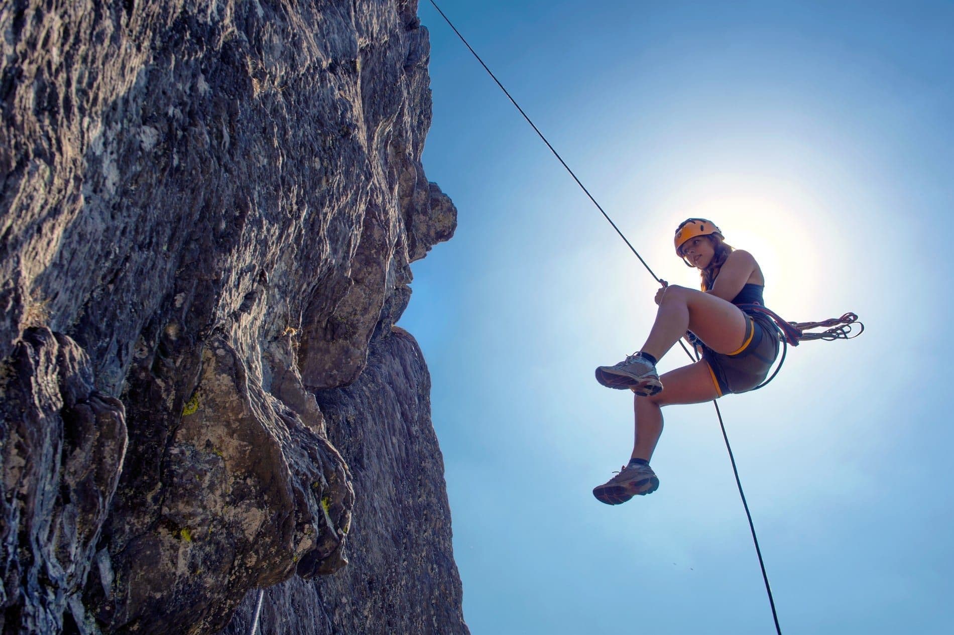 Person mid air while climbing 