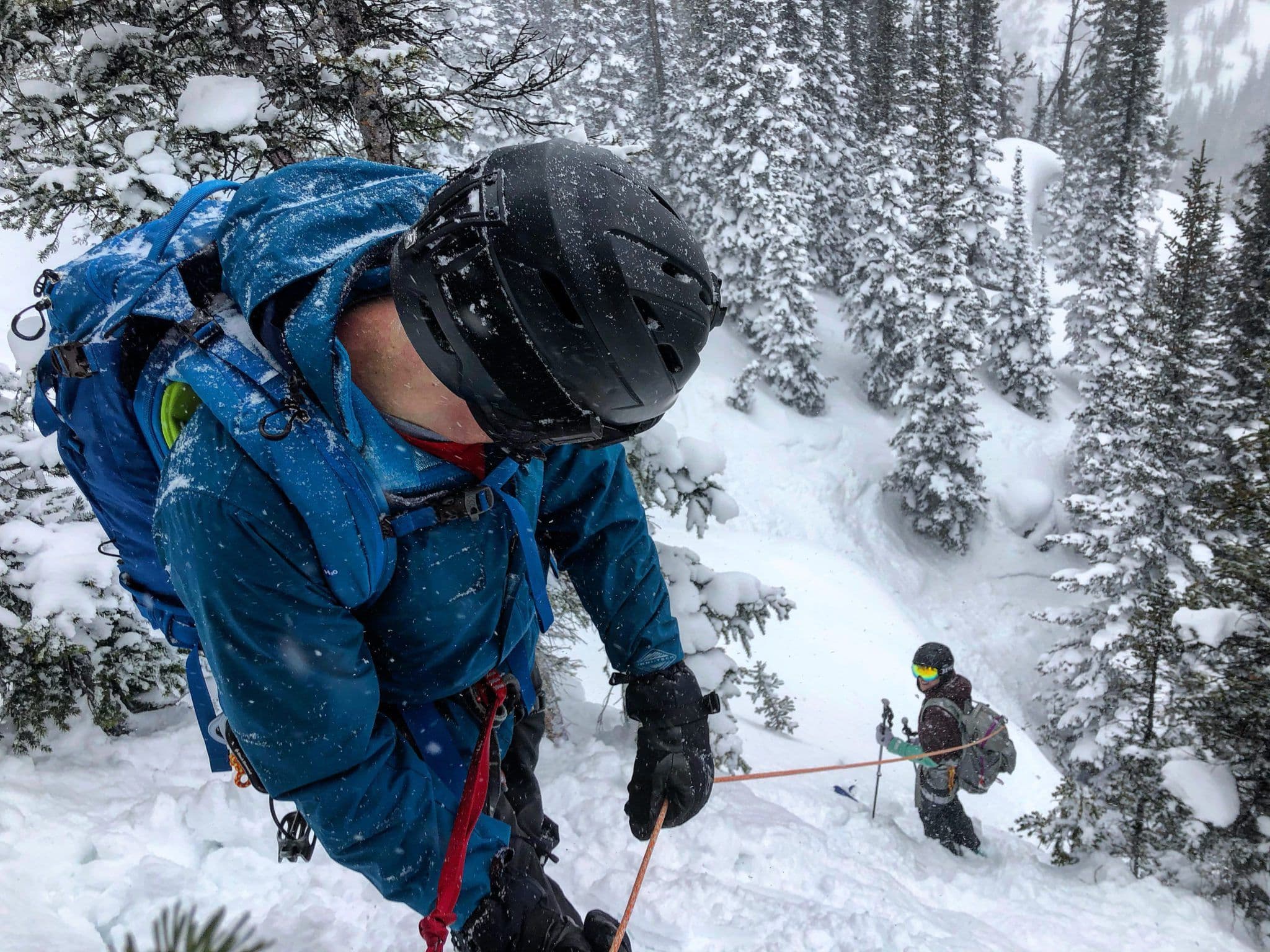 Team going down mountain in powder