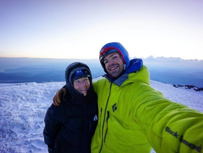 Two people celebrating their climb to the summit