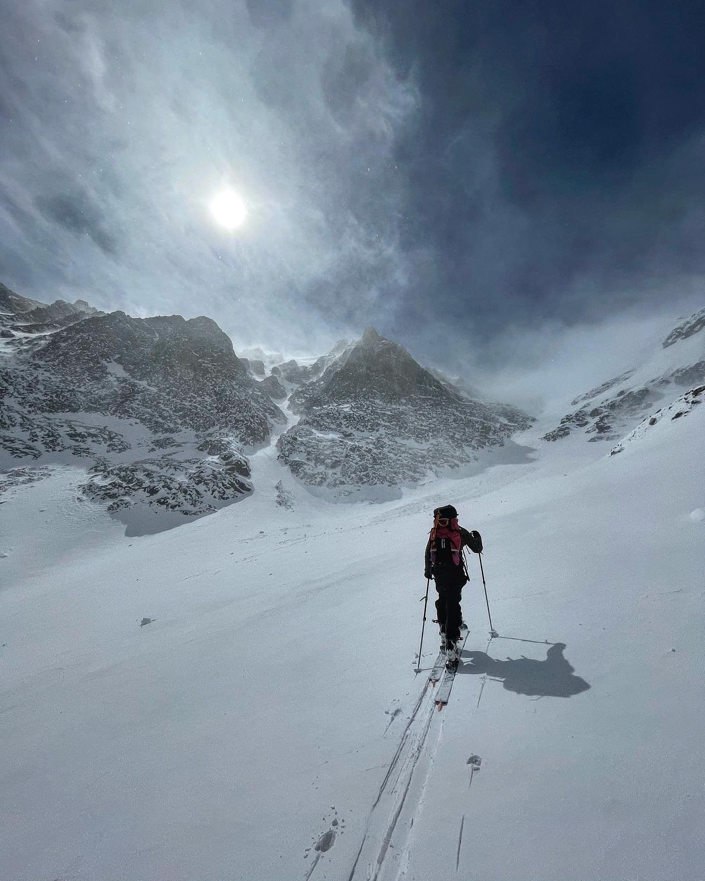 Skier hiking up snowy mountains