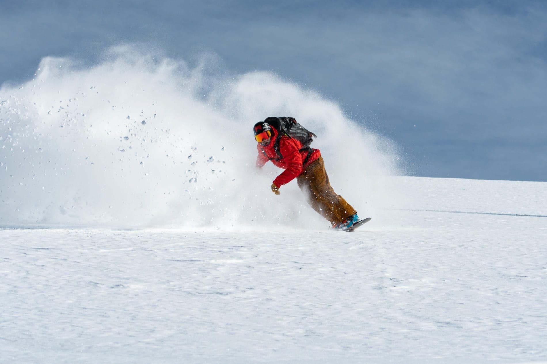 Snowboarder carving down a mountain