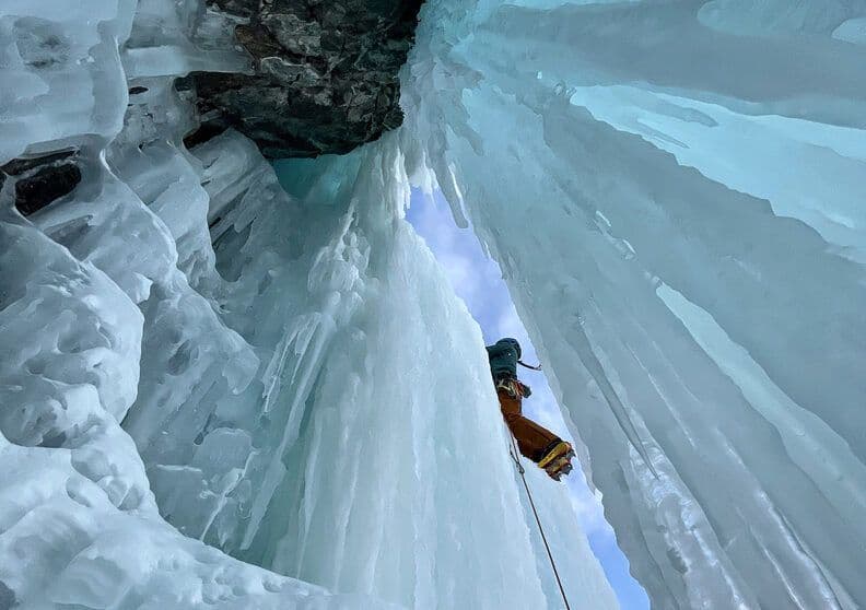 Person ice climbing a waterfall