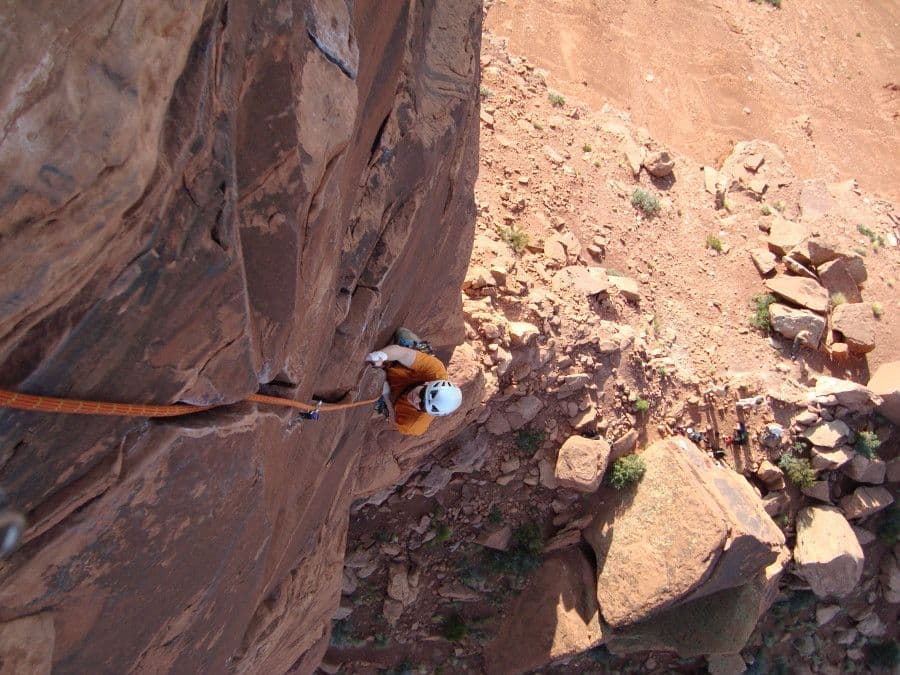 Rock climber in Moab scaling rockside
