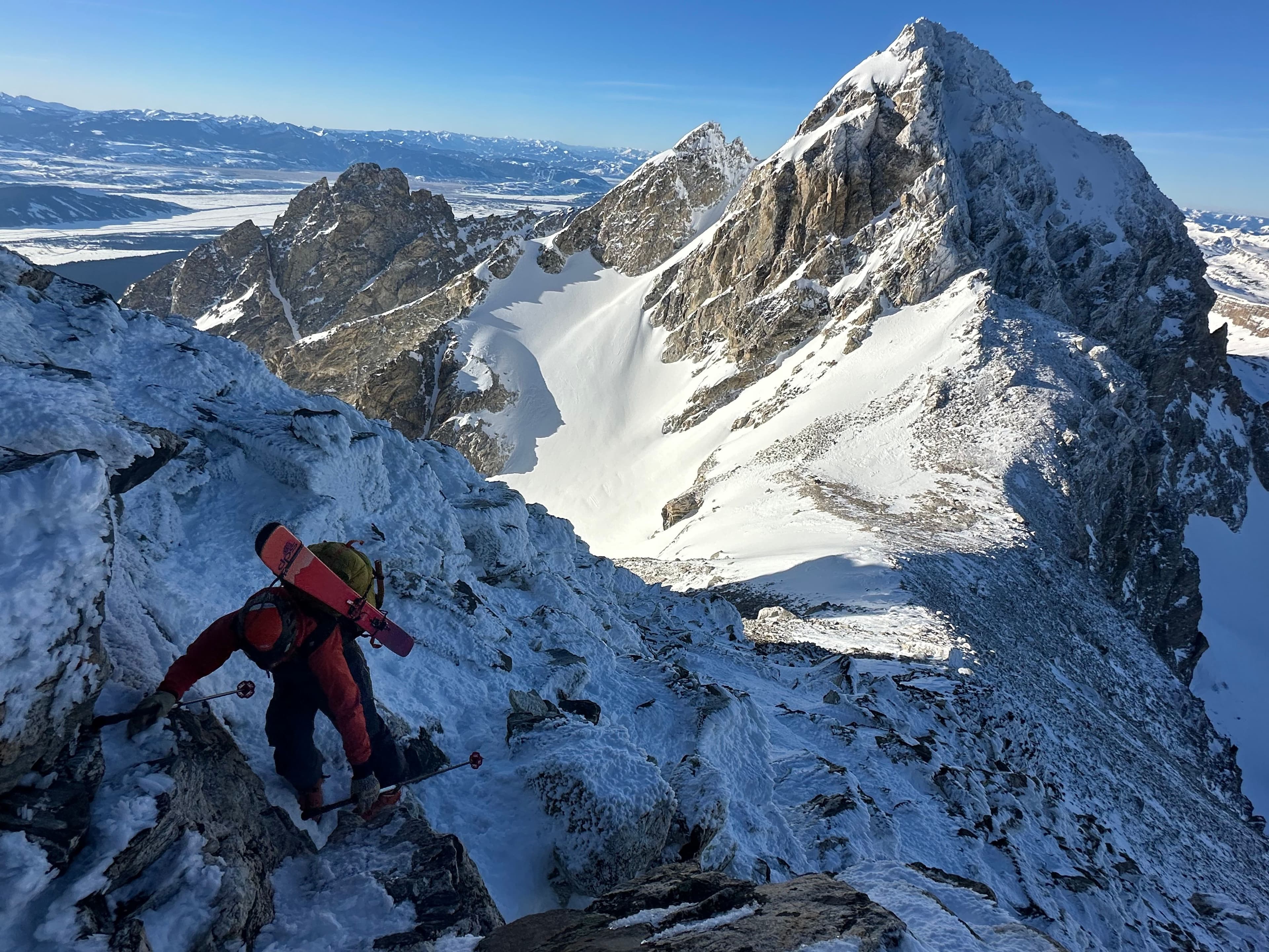 Skier carving down rocky terrain