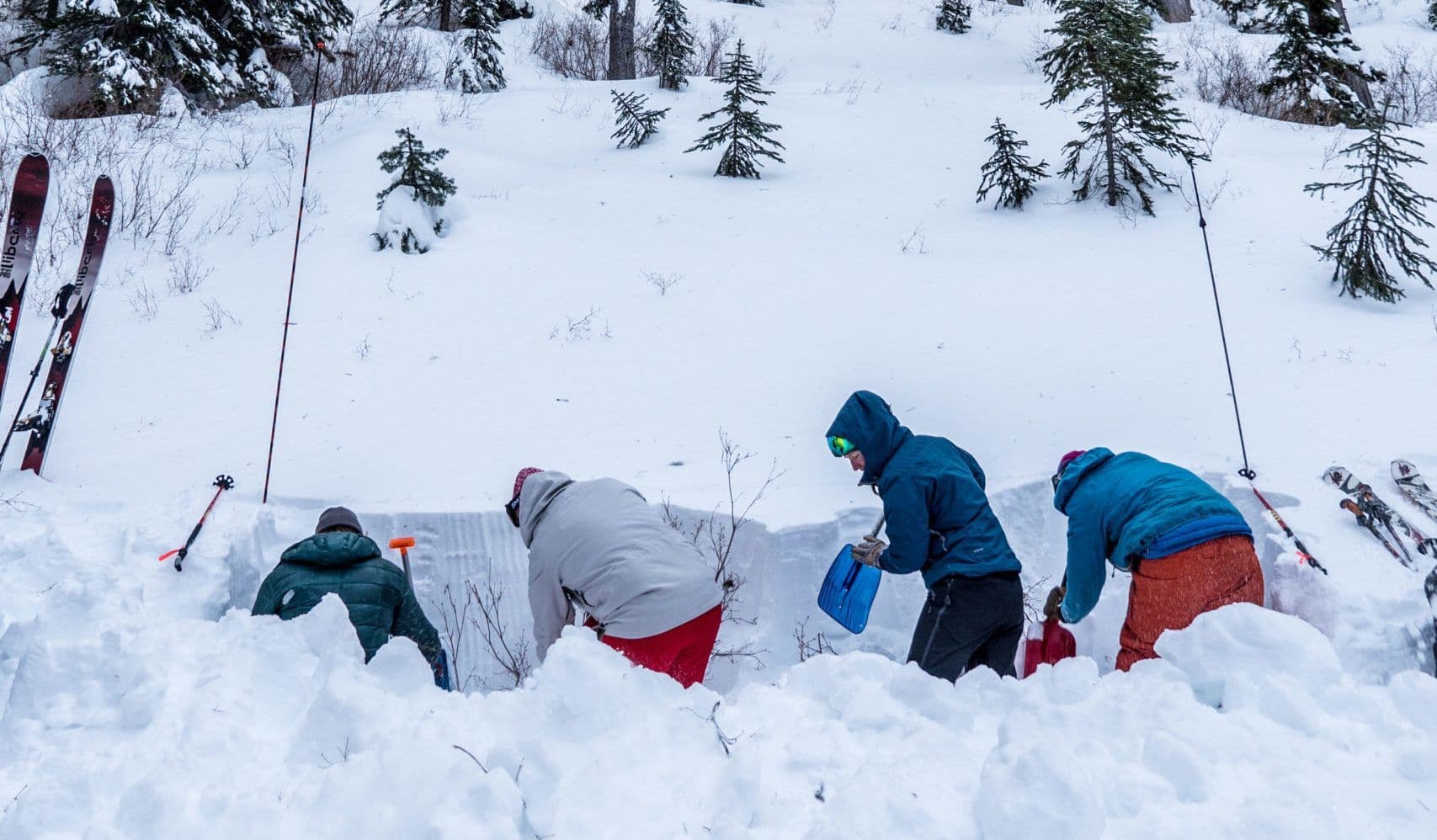 People shoveling on avalanche course