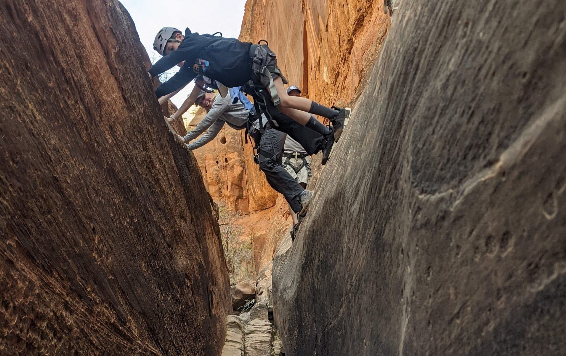 People canyoneering through a narrow passage