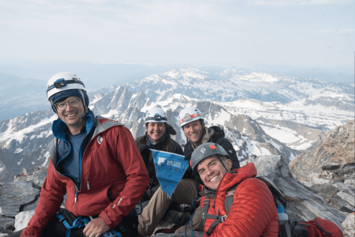 Group photo of happy climbers at the summit