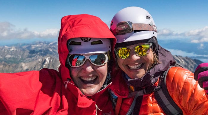 Two women celebrate summiting the Grand Teton in Grand Teton National Park.