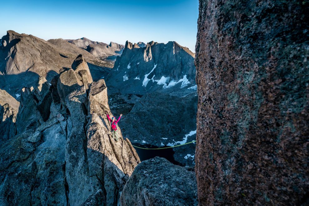 Rock climber celebrates while climbing Wolf's Head in the Wind River Range.