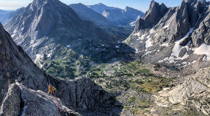 Rock climber in the Wind River Mountain Range on a sunny summer day.